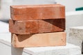 Stack of orange bricks on construction site Royalty Free Stock Photo