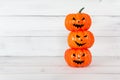Stack of orange ghost pumpkin on white wood table with copy space , halloween concept