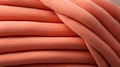 A stack of orange knitted fabric background