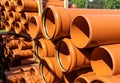 Stack of orange pipes at a construction site Royalty Free Stock Photo