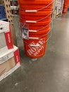 A stack of orange plastic busckets Home Depot home improvement store that have the company logo on them Royalty Free Stock Photo