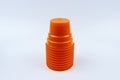 Stack of orange plastic cups isolated on white background Royalty Free Stock Photo