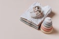 Stack of organic cotton bodysuits, rompers, baby shoes and silicone toys, pyramid. Fashion newborn pastel colors clothes Royalty Free Stock Photo