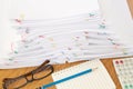 Stack of overload paper and reports on brown wood table Royalty Free Stock Photo