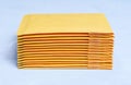 Stack of Padded Envelopes on Grey Background