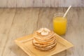 Stack Of Pancakes With Bananas and Fresh Orange Juice