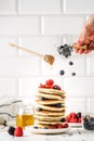 stack of pancakes with berries levitation