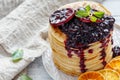 Stack of pancakes with berry sauce.