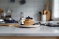 A stack of pancakes with blueberries on top of a white plate Royalty Free Stock Photo