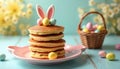 Stack of pancakes on bunny plate. Sweet dessert with Easter eggs and ears decoration. Holiday breakfast with basket on light blue Royalty Free Stock Photo