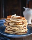 Stack of pancakes with butteron wooden background Royalty Free Stock Photo