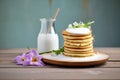 stack of pancakes with coconut milk dribble, side view