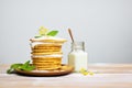 stack of pancakes with coconut milk dribble, side view