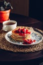 Stack of pancakes with cornelian cherry jam on plate Royalty Free Stock Photo