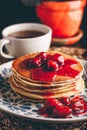Stack of pancakes with cornelian cherry jam on plate Royalty Free Stock Photo