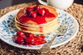 Stack of pancakes with cornelian cherry jam on plate Royalty Free Stock Photo