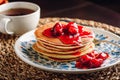 Stack of pancakes with cornelian cherry jam on plate Royalty Free Stock Photo