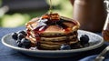 Fluffy Stack of Pancakes with Maple Syrup and Fresh Blueberries on a Plate Royalty Free Stock Photo