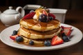 stack of pancakes, drizzled with syrup and topped with fresh fruit Royalty Free Stock Photo