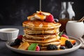 stack of pancakes, drizzled with syrup and topped with fresh fruit Royalty Free Stock Photo