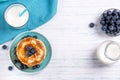 Stack of pancakes with fresh blueberry, honey and milk, healthy breakfast concept, top view Royalty Free Stock Photo