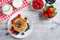 Stack of pancakes with fresh blueberry, raspberry and honey, milk and fresh berries, healthy breakfast concept, top view Royalty Free Stock Photo