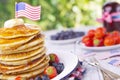 Stack of pancakes with fresh fruit, syrup and butter Royalty Free Stock Photo