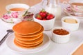 Stack of pancakes with fresh strawberries, butter, marmelade an Royalty Free Stock Photo