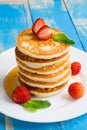 Stack of pancakes fritters with strawberries and honey on a pl Royalty Free Stock Photo