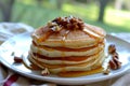 stack of pancakes with honey drizzle and nuts, side view Royalty Free Stock Photo