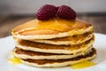 Stack of pancakes with honey and raspberry on white plate Royalty Free Stock Photo