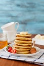 Stack of pancakes with honey syrup, butter and strawberry in a white plate Royalty Free Stock Photo