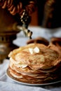 A stack of pancakes with a melting piece of butter. Russian tea party