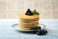 Stack of pancakes with pile of blueberries on plate Royalty Free Stock Photo