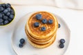 Stack of pancakes on plate with blueberries, top view Royalty Free Stock Photo