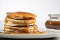 A stack of pancakes on a plate with syrup. Generative AI image.