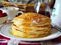 A stack of pancakes on a plate with syrup