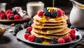 A stack of pancakes with raspberries and blueberries on top Royalty Free Stock Photo