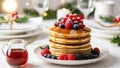 Stack of pancakes with syrup and berries on a blurred Christmas table setting background. Royalty Free Stock Photo