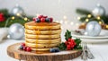 Stack of pancakes with syrup and berries on a blurred Christmas table setting background. Royalty Free Stock Photo