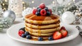 Stack of pancakes with syrup and berries on a blurred Christmas table setting background. Royalty Free Stock Photo