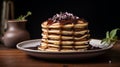 A stack of pancakes with a syrup and berry on black plate. Sweet pancake on a plate. Sweet dessert Royalty Free Stock Photo