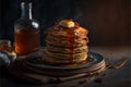 a stack of pancakes with syrup and a bottle of syrup on a table with a spoon and napkins on it, and a plate with a fork