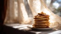 Stack Of Pancakes With Syrup In Warm Sunlight By Window. Cozy Breakfast Scene With Natural Light Royalty Free Stock Photo