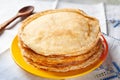 Stack of pancakes. Thin pancakes in a plate and a wooden spoon. Traditional rustic food Royalty Free Stock Photo