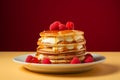 a stack of pancakes topped with whipped cream and raspberries