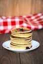 Stack of pancakes white plate with cherry jam, red napkin, brow Royalty Free Stock Photo