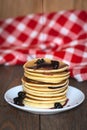 Stack of pancakes white plate with cherry jam, red napkin, brow Royalty Free Stock Photo