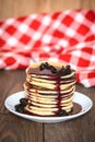 Stack of pancakes white plate with cherry jam, red napkin, brow Royalty Free Stock Photo