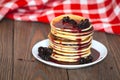 Stack of pancakes white plate with cherry jam, red napkin, brow Royalty Free Stock Photo